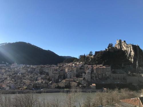 a view of a city with a mountain at Hotel Les Chênes in Sisteron