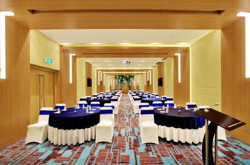 a large banquet hall with tables and chairs in it at Holiday Inn Bengaluru Racecourse by IHG in Bangalore