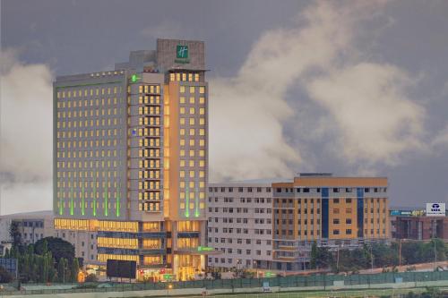 a tall building with lights on in a city at Holiday Inn Bengaluru Racecourse by IHG in Bangalore