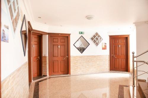 a hallway with two doors and a staircase at Beyaz Konak Evleri in Datca