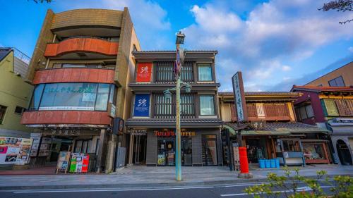 a building on the corner of a city street at GEN HOTEL KAMAKURA in Kamakura