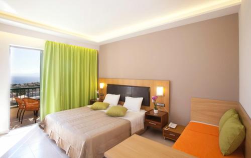 a bedroom with two beds and a green curtain at Pefkos Beach Studios & Apartments in Pefki Rhodes