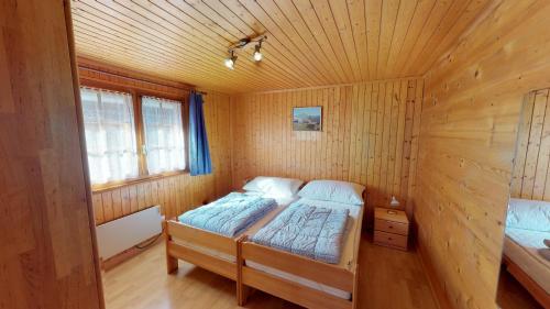 a bedroom with a bed in a wooden cabin at Gustav GS2 in Blatten bei Naters