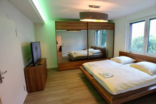 ein Schlafzimmer mit einem großen Bett und einem Spiegel in der Unterkunft Porschenahe Wohung in Stuttgart