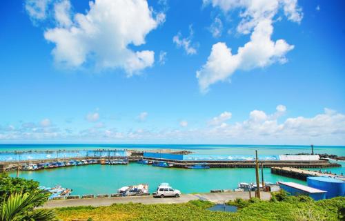 a view of a marina with a white van in the water at Lugo Hotel in Manzhou