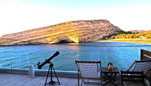 a view of the water from a balcony with a telescope at Matala Caves in Matala