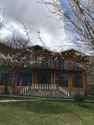 a large wooden house with a porch at Harsnadzor Eco Resort in Halidzor