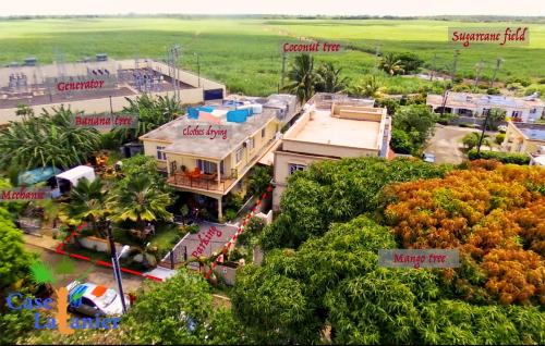 an aerial view of a house with trees and buildings at Case Latanier in Beau Champ