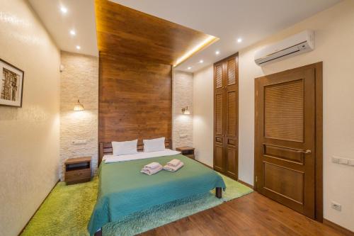 a bedroom with a bed with two towels on it at Petrani Nivki in Kyiv