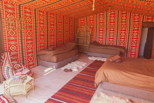 a room with two beds and a couch at Arabian Nights in Wadi Rum
