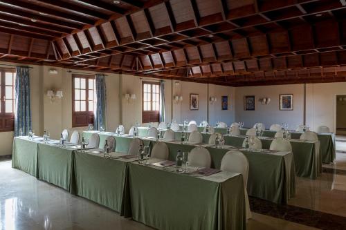 
a large room filled with tables and chairs at Parador de La Palma in Breña Baja
