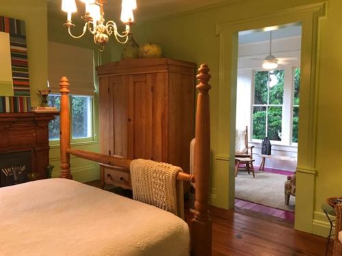 a bedroom with a bed and a chandelier at Elmwood 1820 Bed & Breakfast Inn in Washington