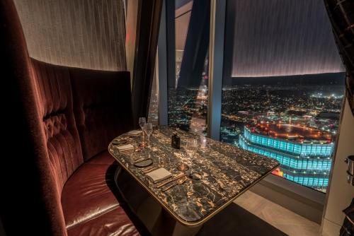 a table in a room with a view of a city at InterContinental - Los Angeles Downtown by IHG in Los Angeles