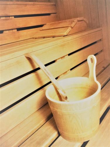 a wooden bowl with two wooden utensils in it at Hotel Vernagt in Senales