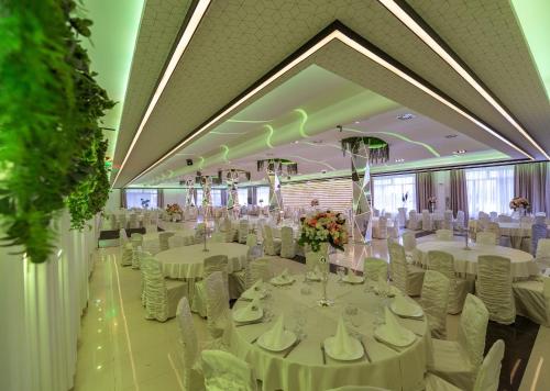 a banquet hall with white tables and white chairs at Hotel Bavka in Leskovac