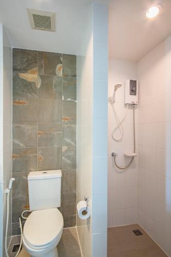 a bathroom with a toilet and a shower at Parida Resort in Bang Tao Beach