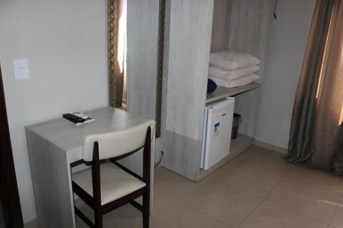 a room with a table and a chair next to a bathroom at Sleep Hotel in Toledo