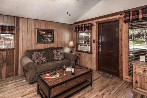 a living room with a couch and a table at Canyon Cabins in Ruidoso