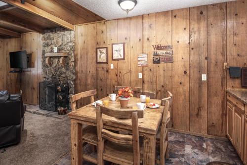 a wooden dining room with a wooden table and chairs at Canyon Cabins in Ruidoso