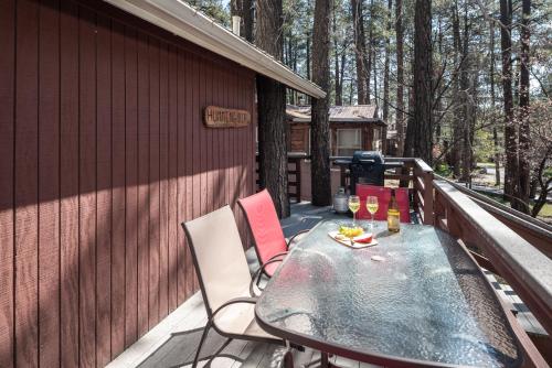 a table and chairs on the deck of a cabin at Canyon Cabins in Ruidoso