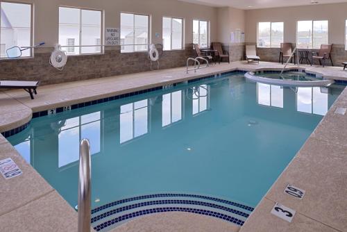 a large pool with blue water in a hotel at Holiday Inn Express & Suites Williams, an IHG Hotel in Williams