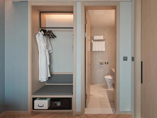 a bathroom with a walk in closet with a toilet at Sono Calm Goyang in Goyang