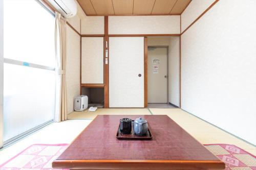 a table in the middle of a room at Business Ryokan Akashiya Annex in Akashi