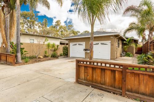 a house with white garage doors and palm trees at @ Marbella Lane 6BR Duplex in Downtown San Jose in San Jose
