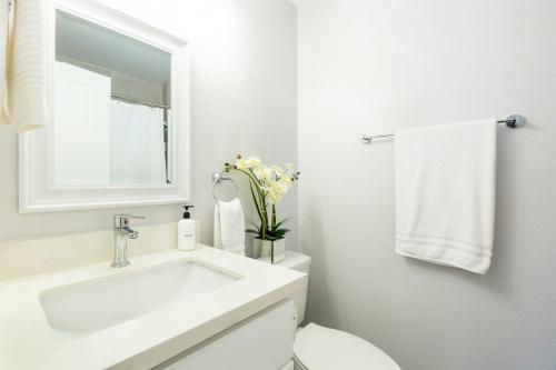 a white bathroom with a sink and a toilet at @ Marbella Lane 6BR Duplex in Downtown San Jose in San Jose