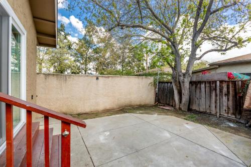 a house with a tree and a fence at @ Marbella Lane 6BR Duplex in Downtown San Jose in San Jose