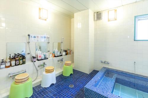 a bathroom with two toilets and a swimming pool at Business Ryokan Akashiya Annex in Akashi