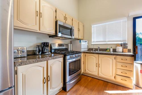 a kitchen with white cabinets and a stove top oven at @ Marbella Lane 6BR Duplex in Downtown San Jose in San Jose