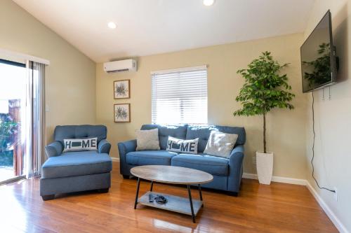 a living room with two blue couches and a table at @ Marbella Lane 6BR Duplex in Downtown San Jose in San Jose