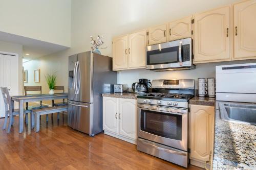 a kitchen with stainless steel appliances and a table at @ Marbella Lane 3BR House in Downtown San Jose in San Jose