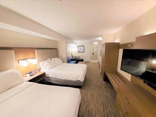 a hotel room with two beds and a flat screen tv at Holiday Inn Express Hotel & Suites Seattle North - Lynnwood by IHG in Lynnwood