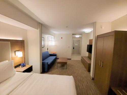 a hotel room with a bed and a couch at Holiday Inn Express Hotel & Suites Seattle North - Lynnwood by IHG in Lynnwood
