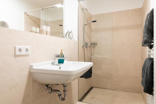 a bathroom with a sink and a shower at Meer-Lust-Sylt Haus Mateika in Westerland (Sylt)