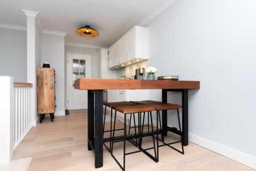 a kitchen with a island in the middle of a room at Meer-Lust-Sylt Haus Mateika in Westerland (Sylt)