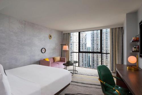 a hotel room with a bed and a large window at The Starling Atlanta Midtown, Curio Collection by Hilton in Atlanta
