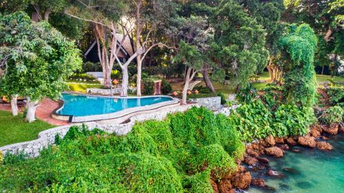 an aerial view of a swimming pool next to a river at The Monttra Pattaya - SHA Extra Plus in Pattaya South