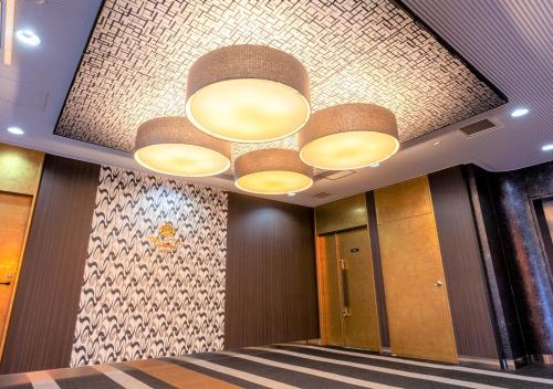 a lobby with a ceiling with lights on it at APA Hotel Saga Ekimae Chuo in Saga