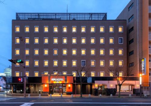 a building on a city street with a traffic light at APA Hotel Saga Ekimae Chuo in Saga