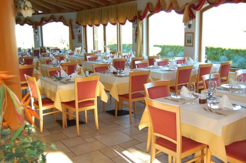 a dining room filled with tables and chairs at Gardenhotel Premstaller in Bolzano