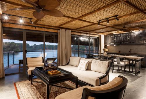 a living room with a couch and a table at Tomodachi Retreat - Làng Mít in Sơn Tây
