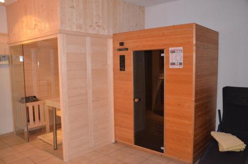 a room with a wooden wall with a door at Gästehaus Garber in Stumm