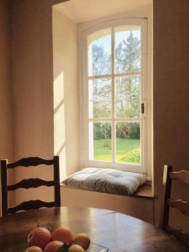a window in a room with a table and a window seat at Maison des Vignes in Le Fleix