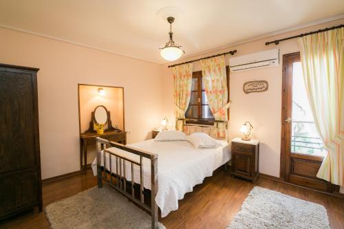 a bedroom with a bed and a mirror at Gastronomy Hotel Kritsa in Portaria