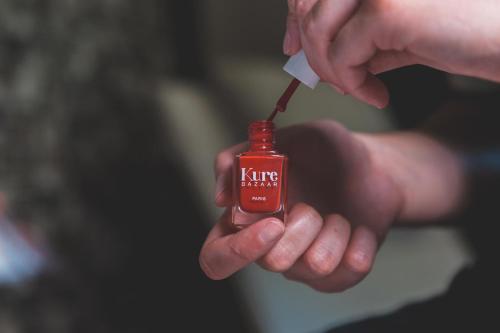a person is holding a bottle of ketchup at Hotel de la Cité Carcassonne - MGallery Collection in Carcassonne