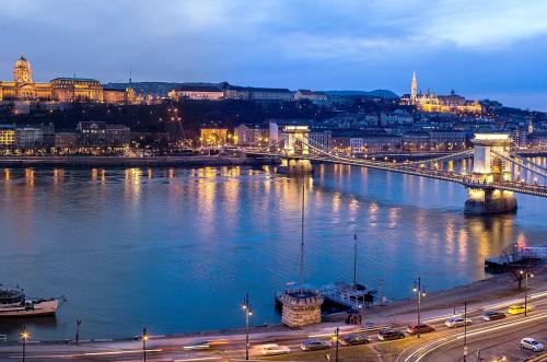 a city with a bridge over a river at night at InterContinental Budapest by IHG in Budapest