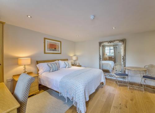a bedroom with a bed and a table and chairs at Marlborough Arms in Woodstock